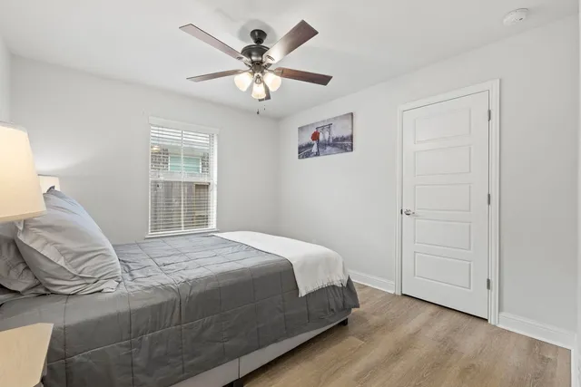 a bathroom with a toilet a sink a mirror a bathtub and vanity