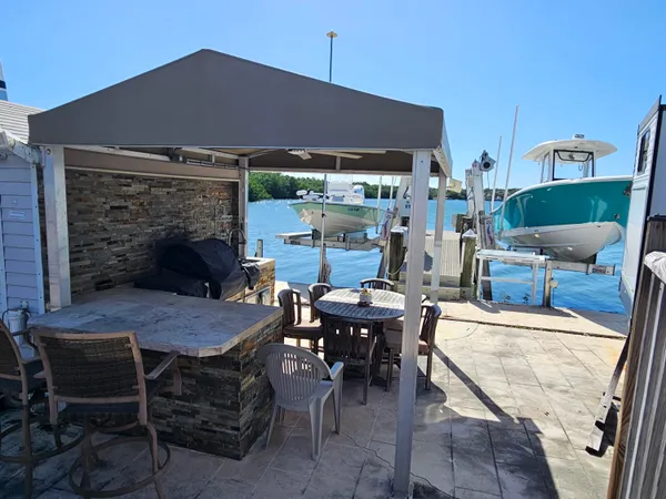 a patio with a table and chairs