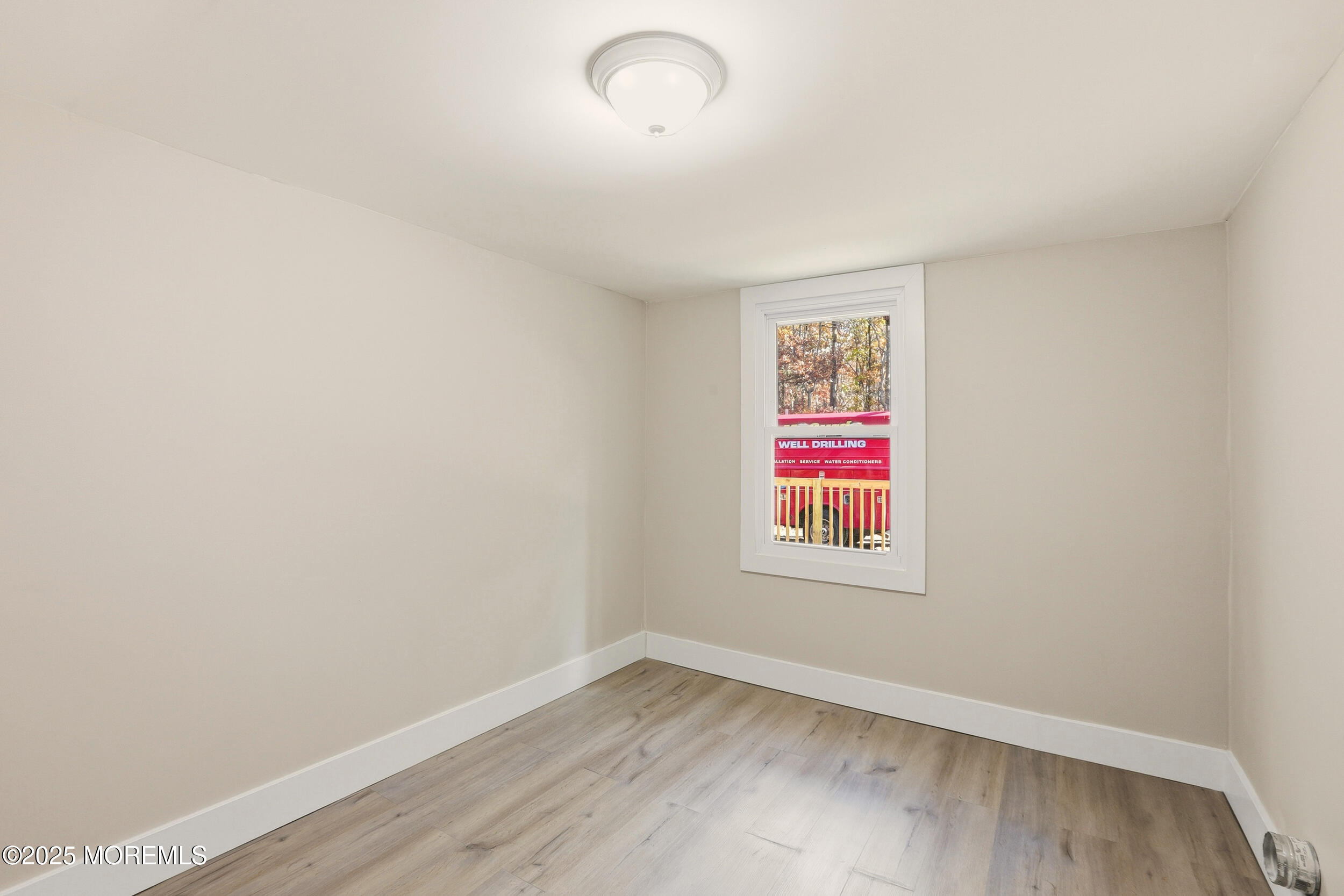 31 Rappleyea Court Howell, NJ 07731 - Photo 11 of 30 an empty room with wooden floor and windows