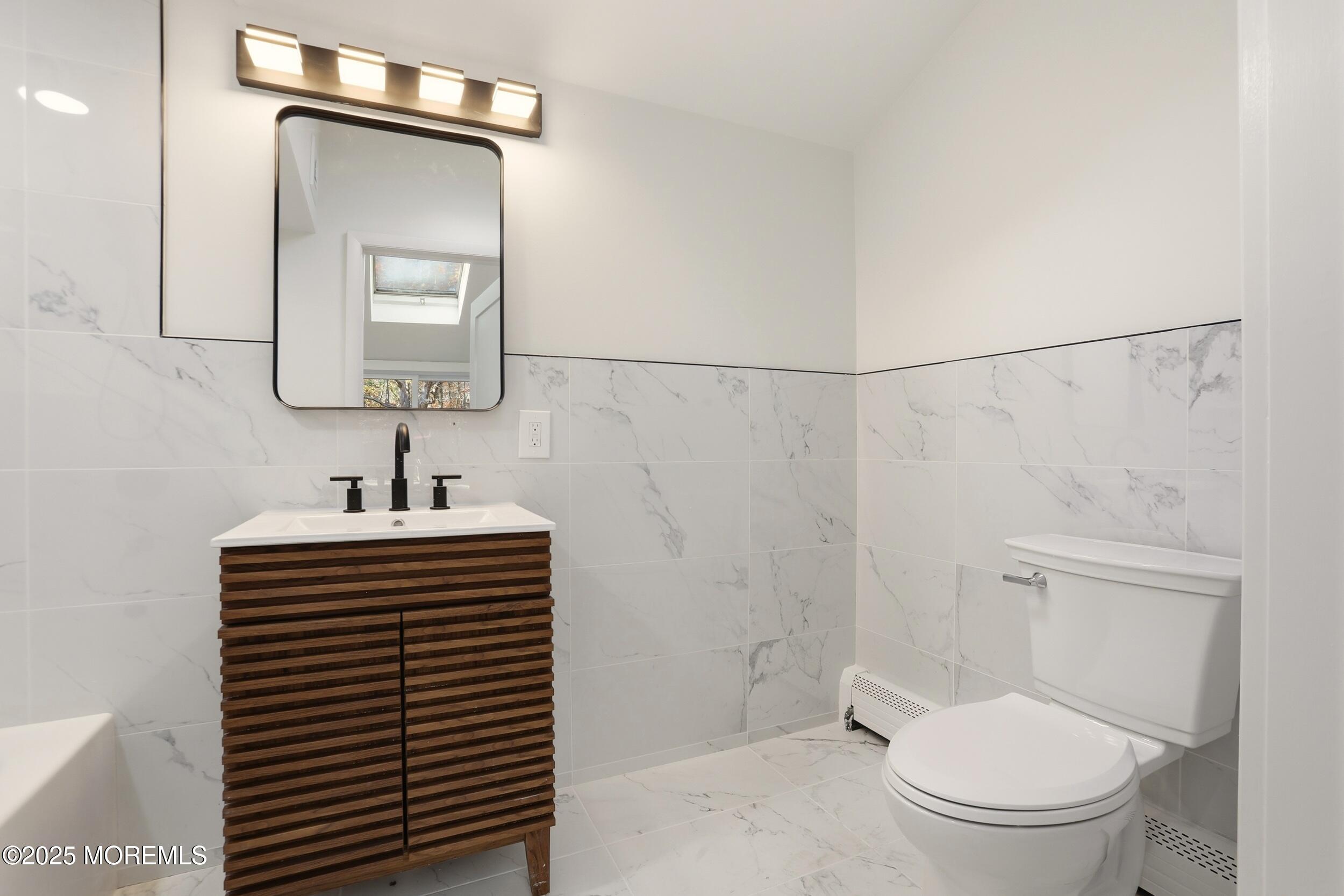 31 Rappleyea Court Howell, NJ 07731 - Photo 14 of 30 a bathroom with a sink a toilet and mirror