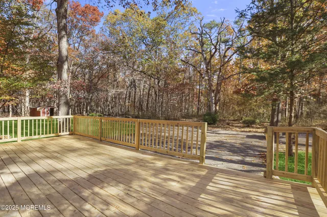 a view of backyard with wooden fence