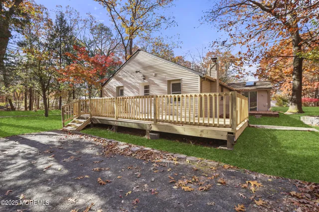 a view of a house with a yard and deck