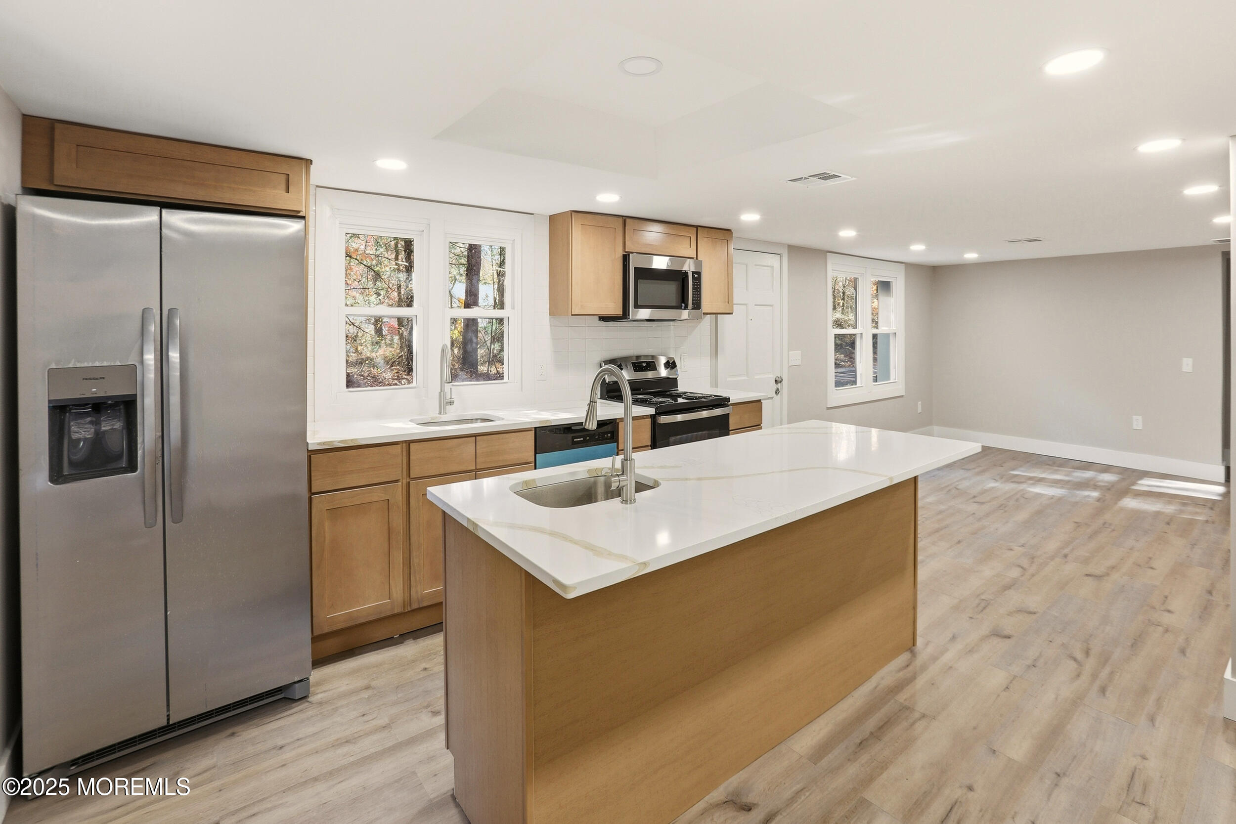 31 Rappleyea Court Howell, NJ 07731 - Photo 4 of 30 a kitchen with stainless steel appliances granite countertop a sink a refrigerator and a stove with wooden floor