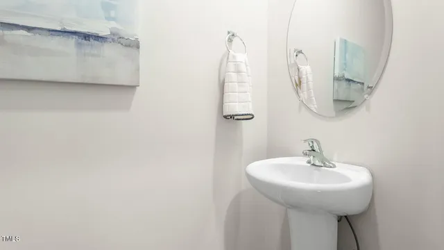 a bathroom with a sink and mirror