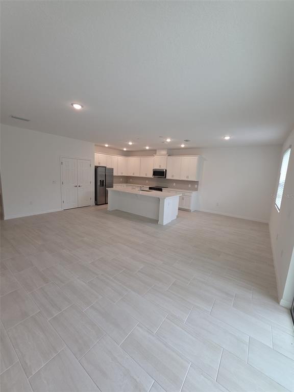 6008 Vision Road St. Cloud, FL 34771 - Photo 16 of 33 a view of kitchen with kitchen island stainless steel appliances a sink and a counter top space in it