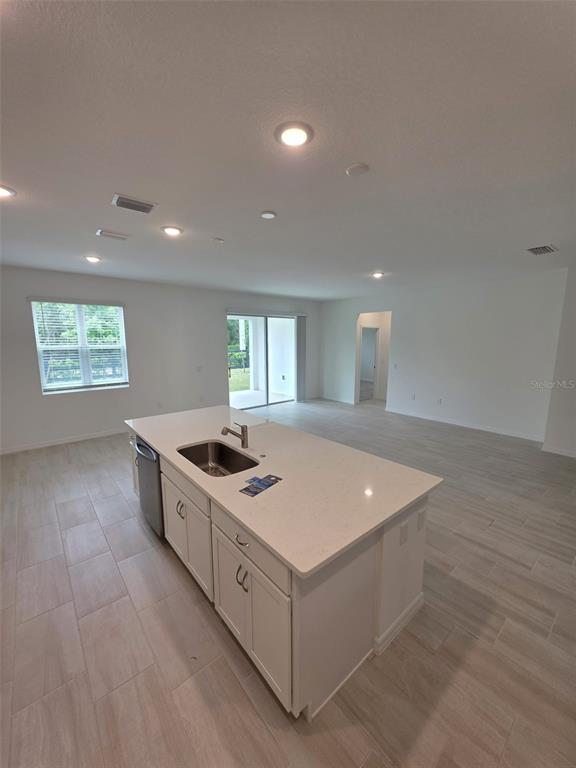 6008 Vision Road St. Cloud, FL 34771 - Photo 18 of 33 a kitchen with stainless steel appliances granite countertop a sink and a stove