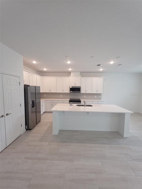 6008 Vision Road St. Cloud, FL 34771 - Photo 20 of 33 a view of kitchen with stainless steel appliances kitchen island