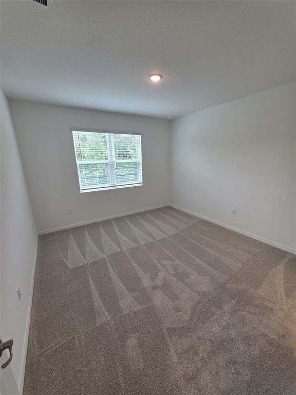 6008 Vision Road St. Cloud, FL 34771 - Photo 21 of 33 an empty room with windows