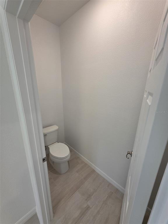 6008 Vision Road St. Cloud, FL 34771 - Photo 25 of 33 a white toilet sitting next to a shower