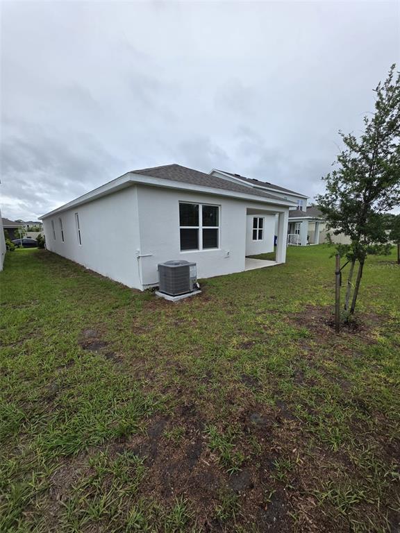 6008 Vision Road St. Cloud, FL 34771 - Photo 31 of 33 a house with a yard