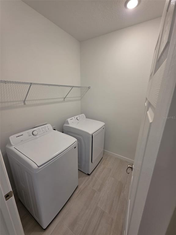 6008 Vision Road St. Cloud, FL 34771 - Photo 6 of 33 a utility room with dryer and washer