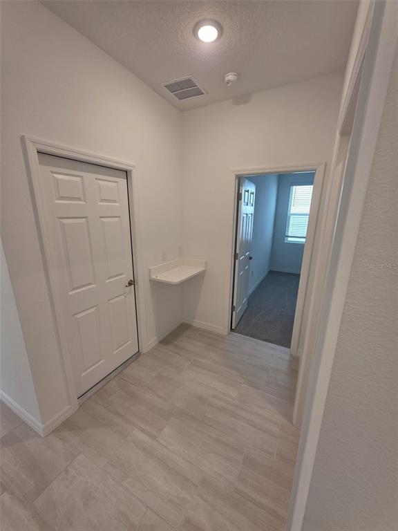6008 Vision Road St. Cloud, FL 34771 - Photo 7 of 33 a view of a hallway to rooms and wooden floor