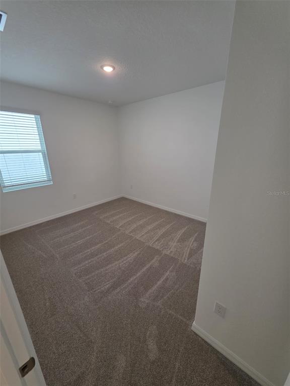 6008 Vision Road St. Cloud, FL 34771 - Photo 8 of 33 an empty room with a workbench