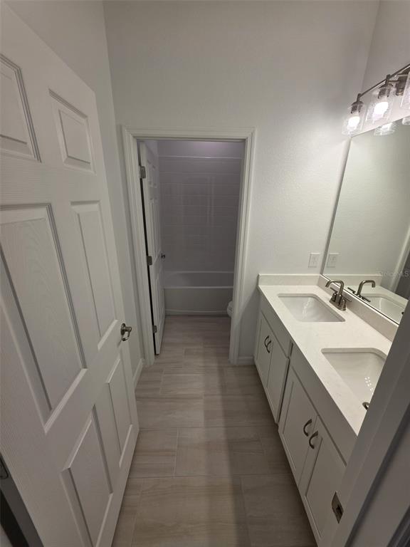 6008 Vision Road St. Cloud, FL 34771 - Photo 10 of 33 a bathroom with a sink a vanity and a mirror
