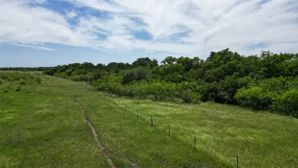 a view of a lake with houses in the back