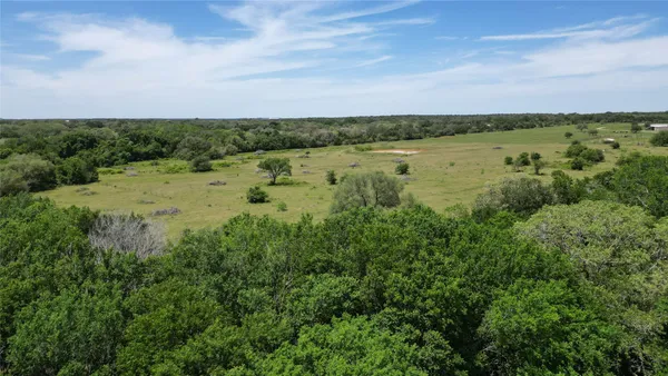 a view of a lake with houses in the back