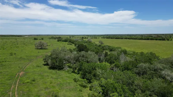 a view of a lake with green field