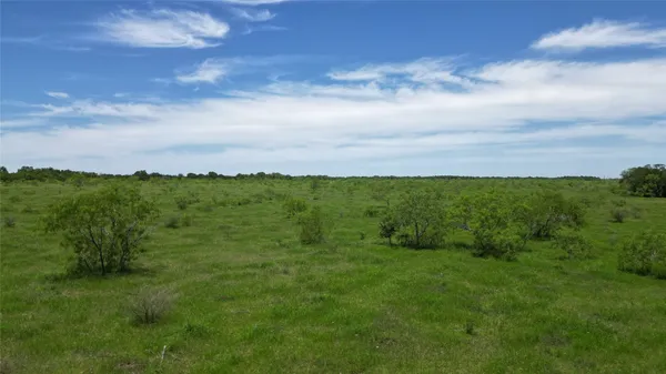 a view of a green field with an outdoor space