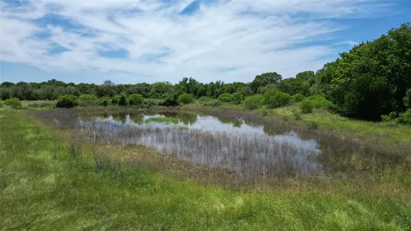 a view of a lake with houses in the back