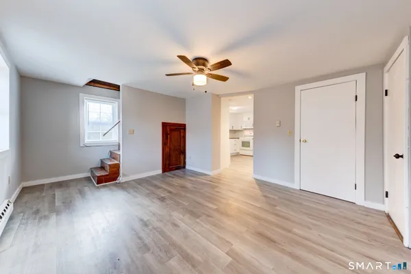 a view of an entryway with wooden floor and door