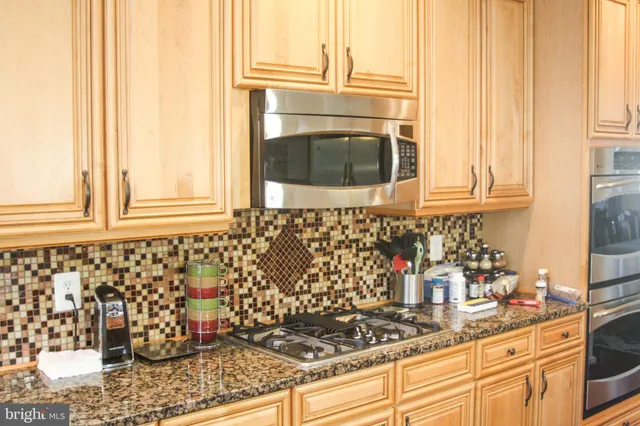 a kitchen with granite countertop a sink and a window