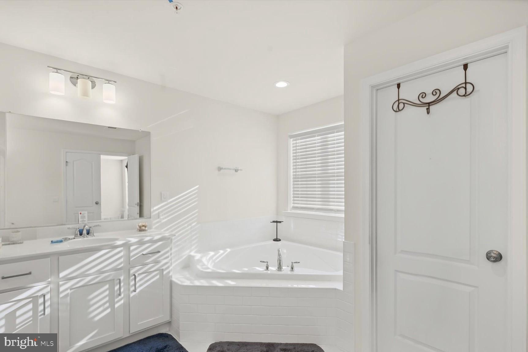 2102 St James Road Accokeek, MD 20607 - Photo 24 of 43 a bathroom with a sink and a mirror