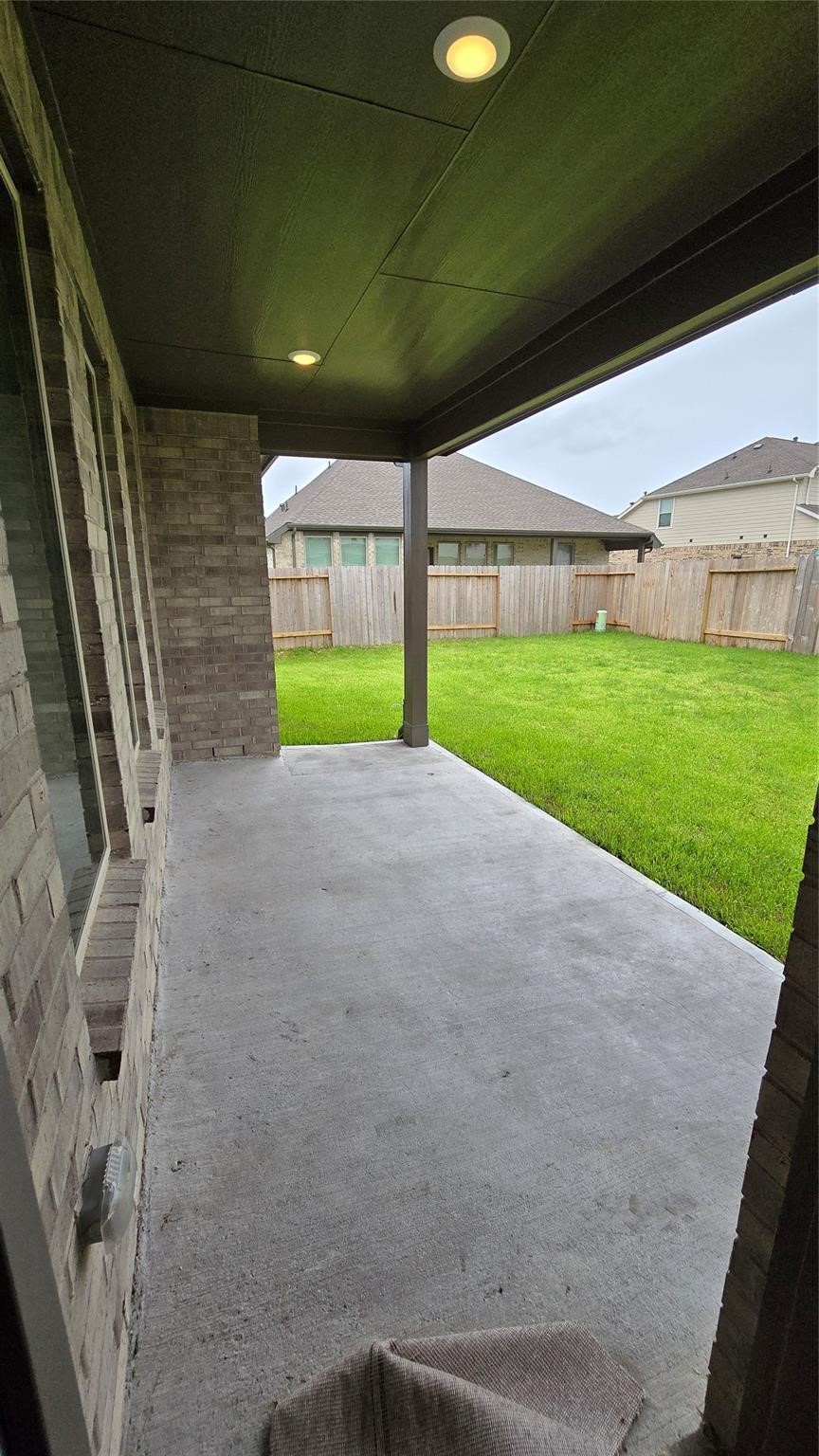 14971 Calluna Heather Lane Conroe, TX 77302 - Photo 14 of 22 a view of a yard with porch and wooden fence