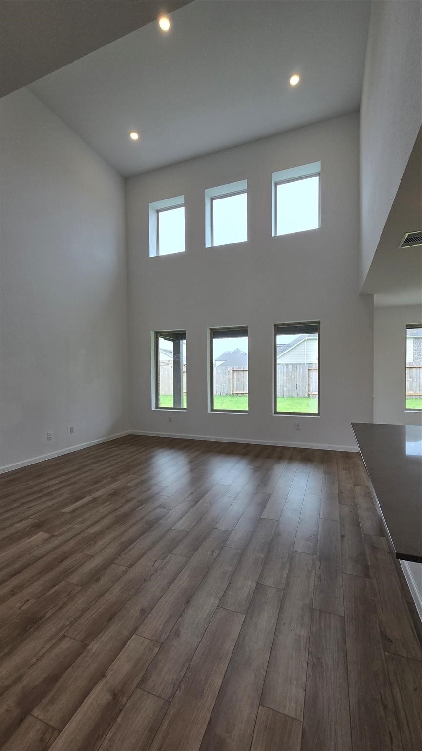 14971 Calluna Heather Lane Conroe, TX 77302 - Photo 4 of 22 an empty room with wooden floor and windows