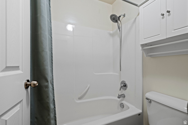 8248 South Resaca Drive, Unit J10 Sandy, UT 84070 - Photo 21 of 40 Bathtub/shower combination featuring a multi-function showerhead with handheld sprayer, integrated grab bar, and chrome fixtures