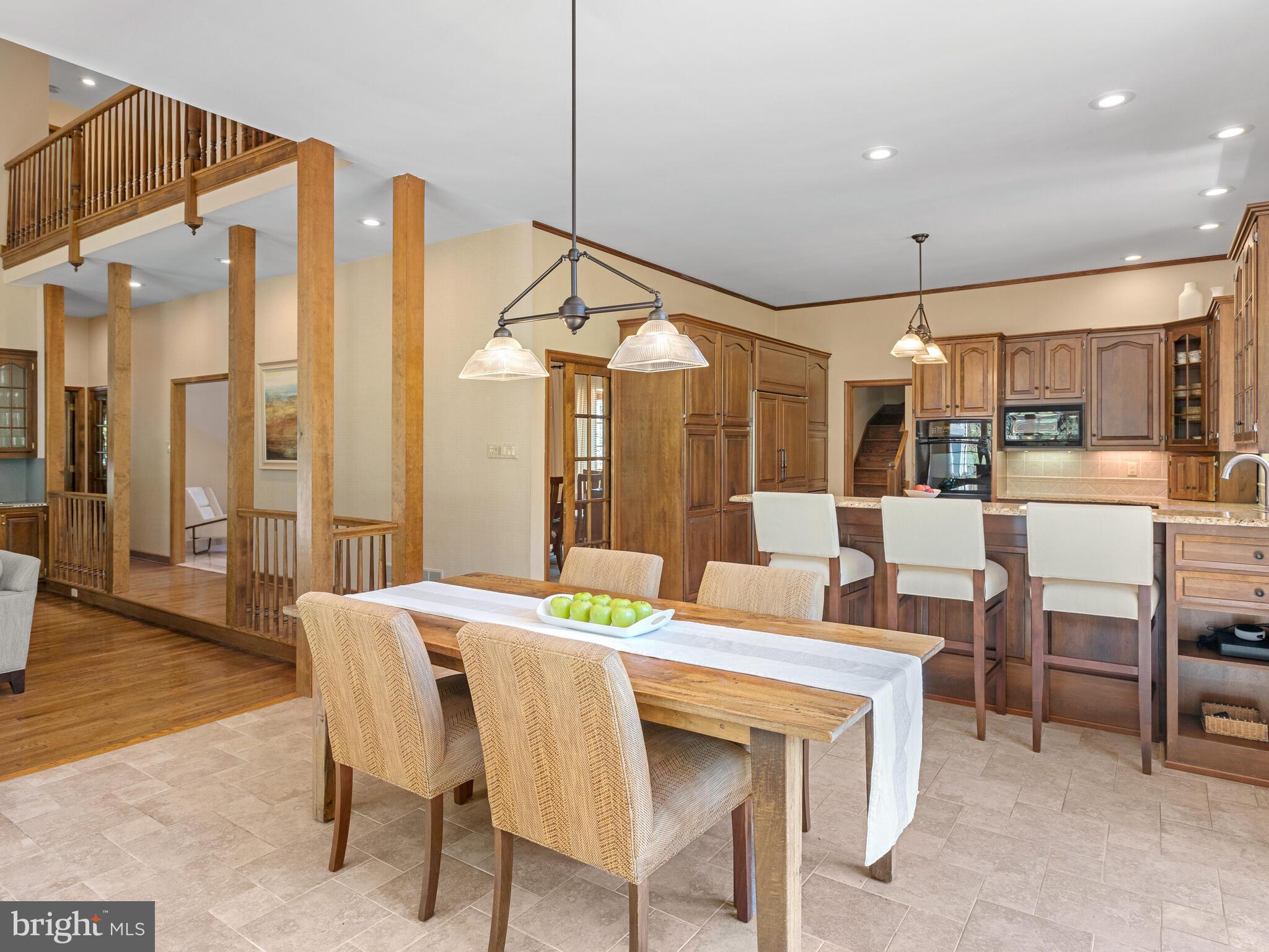 673 Thomas Jefferson Road Wayne, PA 19087 - Photo 13 of 64 a dining hall with stainless steel appliances kitchen island granite countertop a dining table and chairs