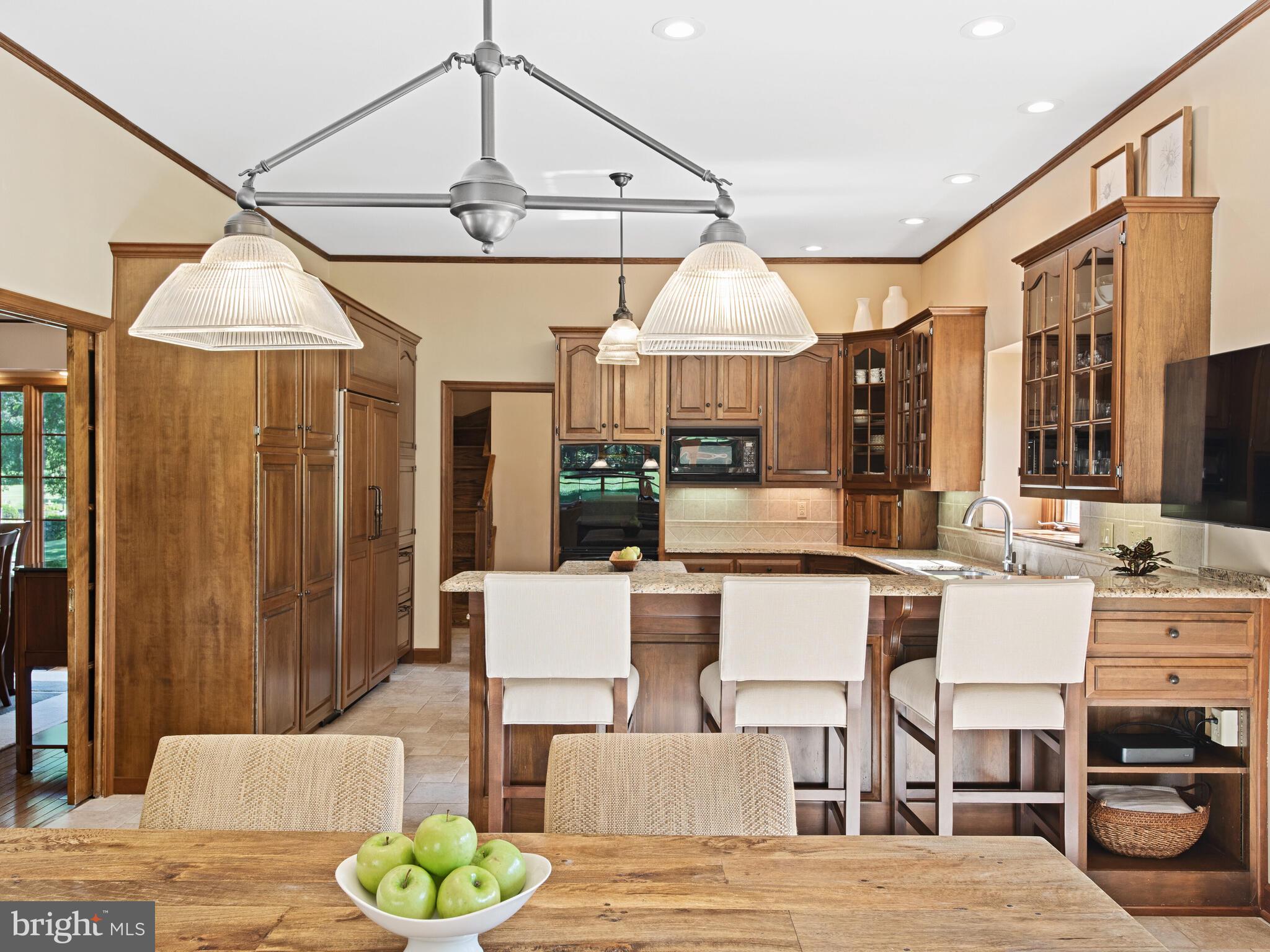 673 Thomas Jefferson Road Wayne, PA 19087 - Photo 19 of 64 a view of a dining room with furniture a chandelier and wooden floor