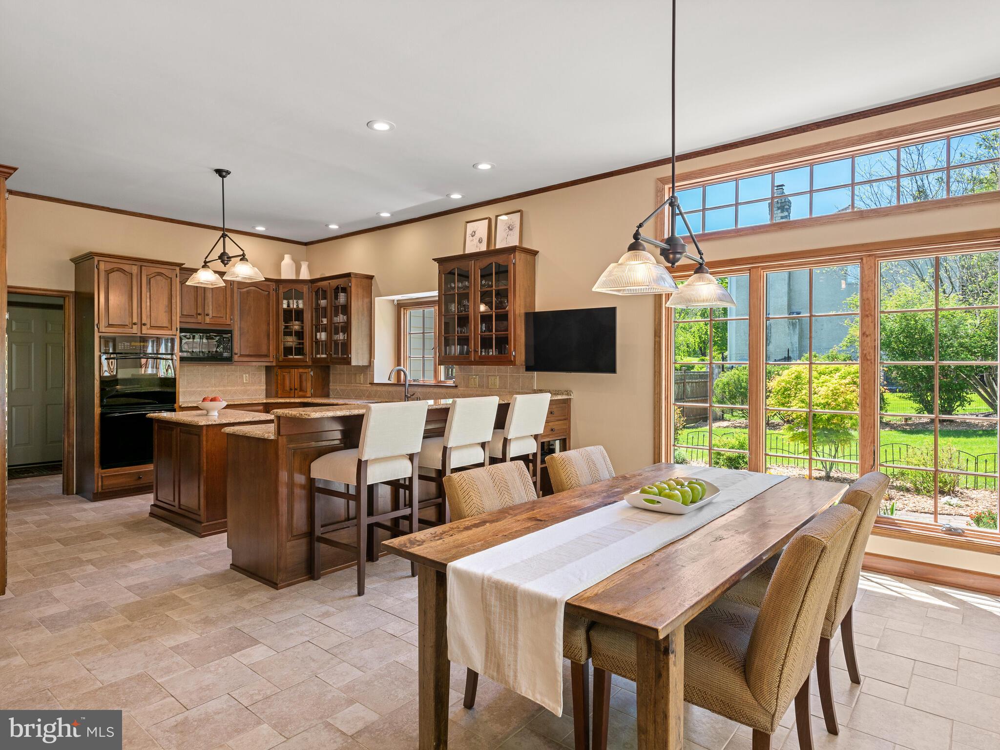 673 Thomas Jefferson Road Wayne, PA 19087 - Photo 21 of 64 a kitchen with a table chairs microwave and refrigerator