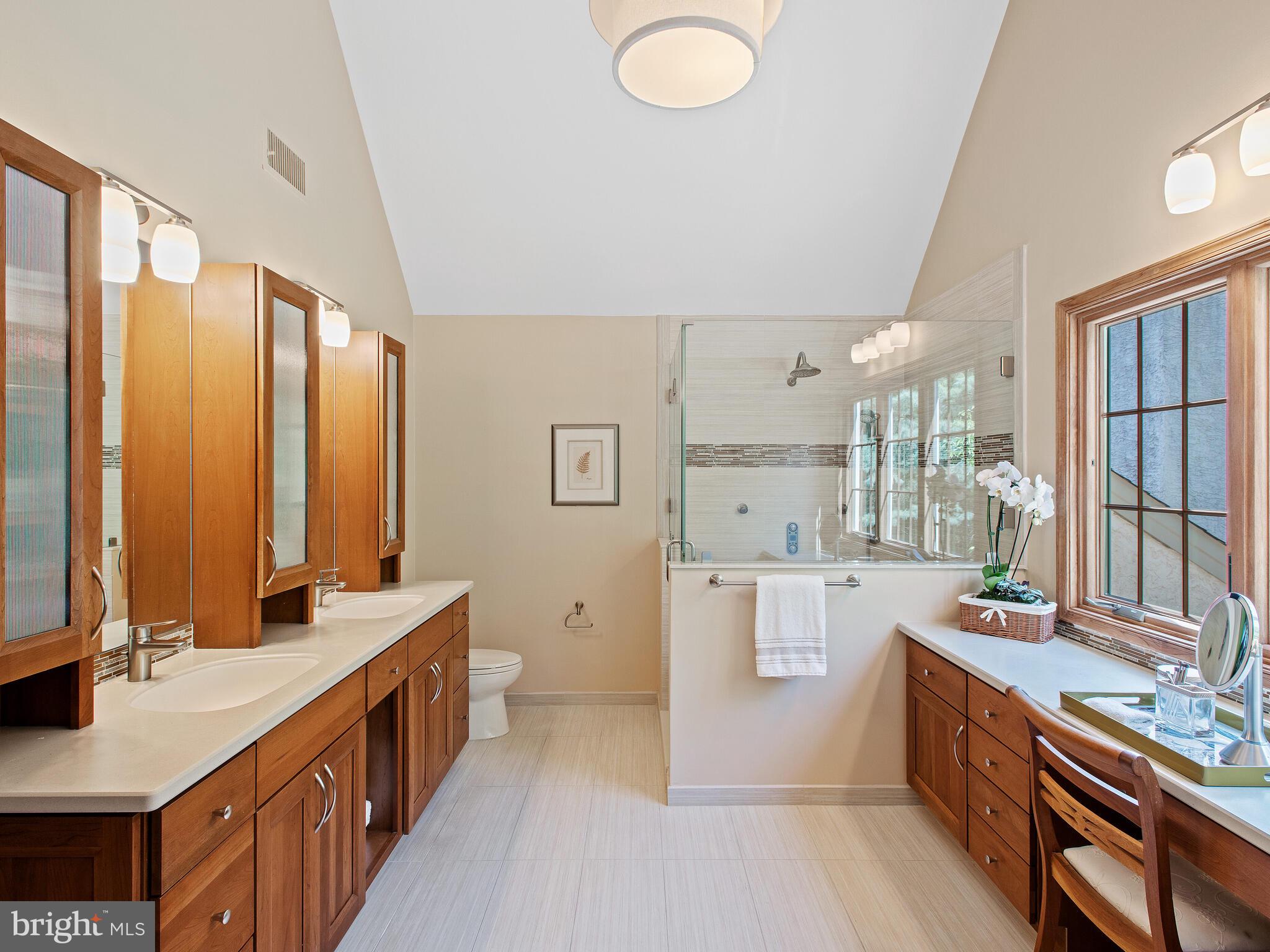 673 Thomas Jefferson Road Wayne, PA 19087 - Photo 32 of 64 a large bathroom with a double vanity sink a mirror and a bathtub