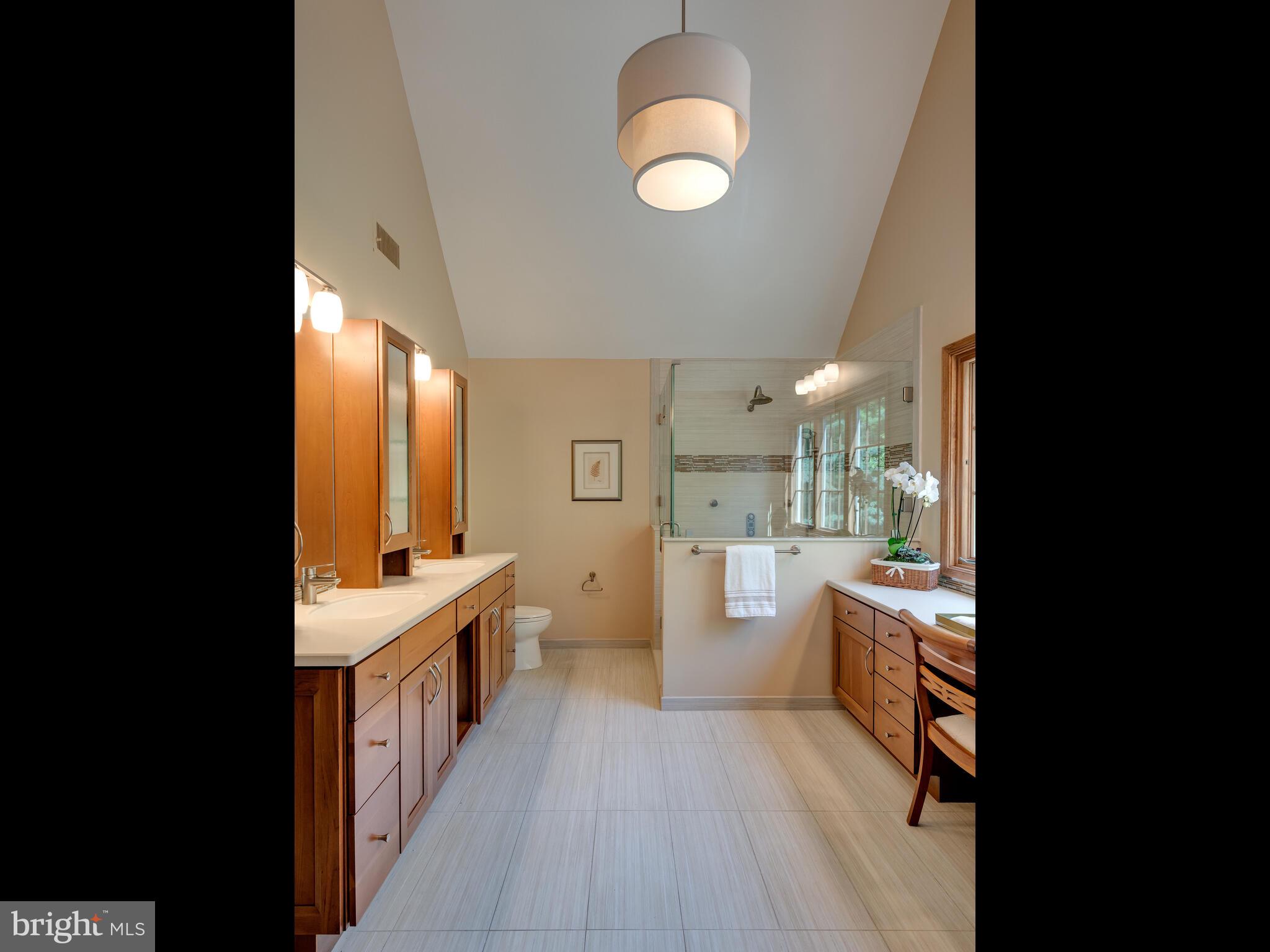 673 Thomas Jefferson Road Wayne, PA 19087 - Photo 33 of 64 a large white kitchen with a large window a sink and stainless steel appliances