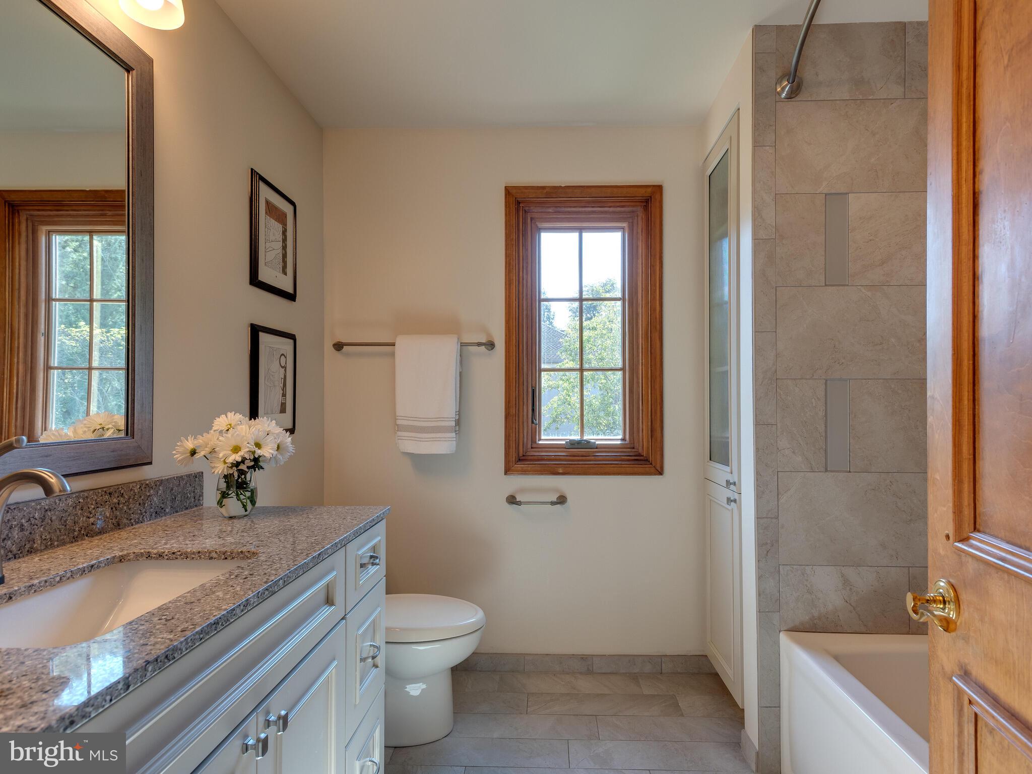 673 Thomas Jefferson Road Wayne, PA 19087 - Photo 37 of 64 a bathroom with a granite countertop sink a toilet and shower