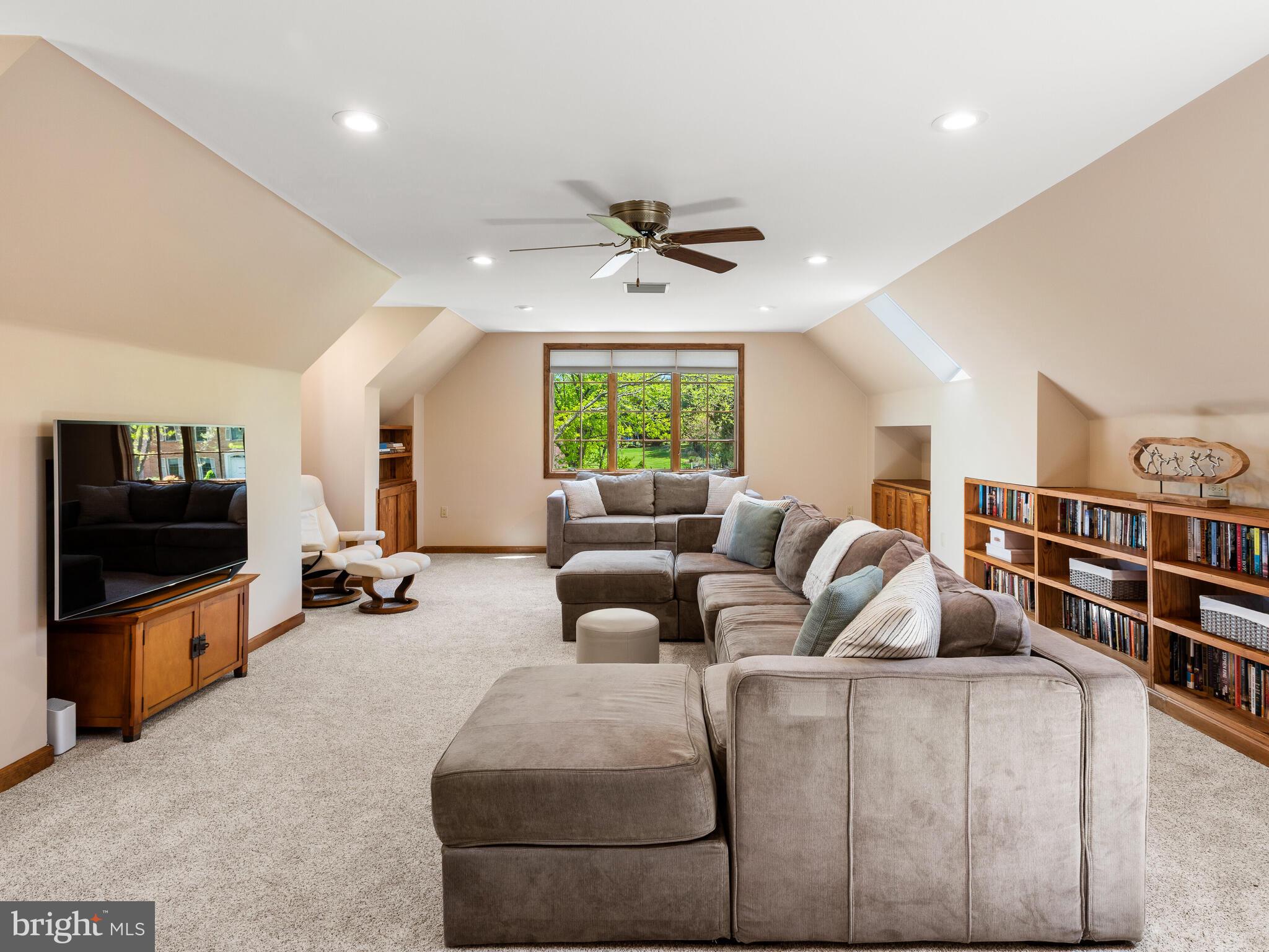 673 Thomas Jefferson Road Wayne, PA 19087 - Photo 41 of 64 a living room with furniture a flat screen tv and a bookshelf