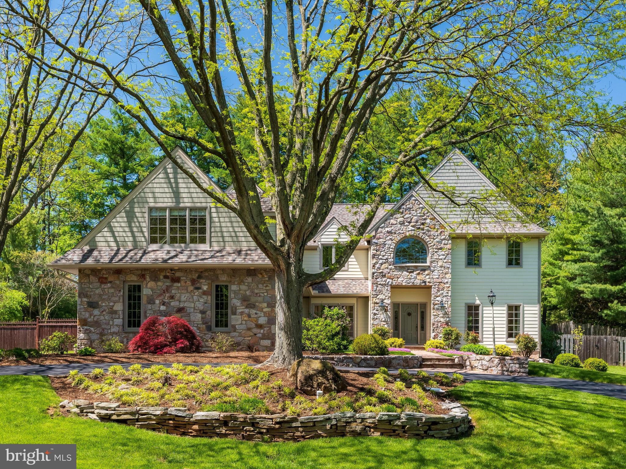 673 Thomas Jefferson Road Wayne, PA 19087 - Photo 64 of 64 a front view of a house with a yard table and chairs