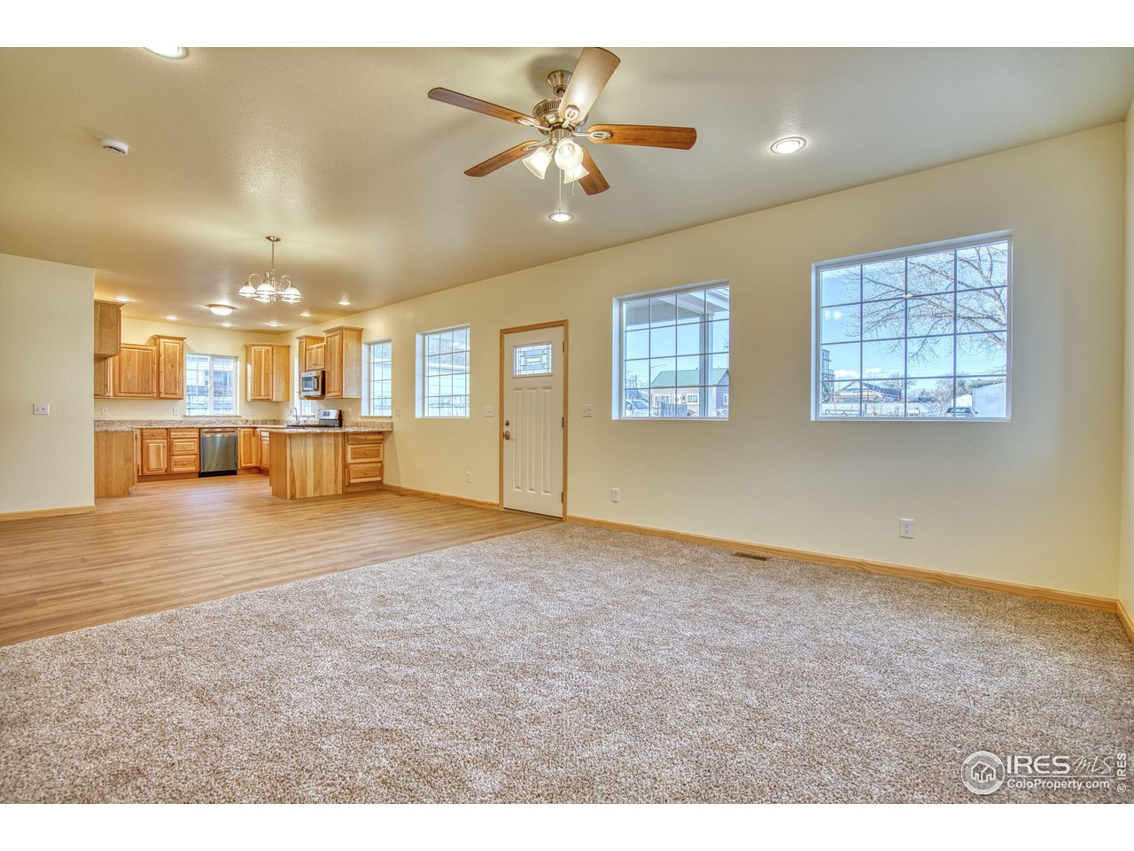 126 2nd Street Mead, CO 80542 - Photo 5 of 22 a view of an empty room with kitchen and window