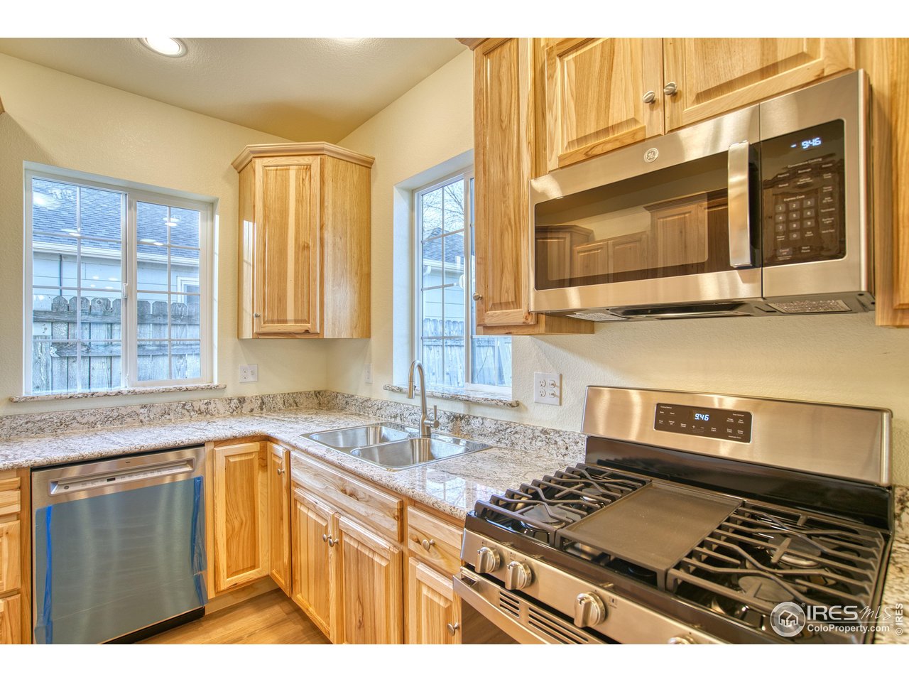 126 2nd Street Mead, CO 80542 - Photo 8 of 22 a kitchen with a stove a sink and a microwave