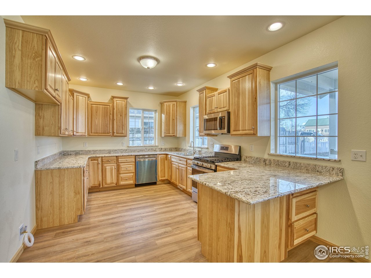 126 2nd Street Mead, CO 80542 - Photo 9 of 22 a kitchen with a stove a sink and a refrigerator