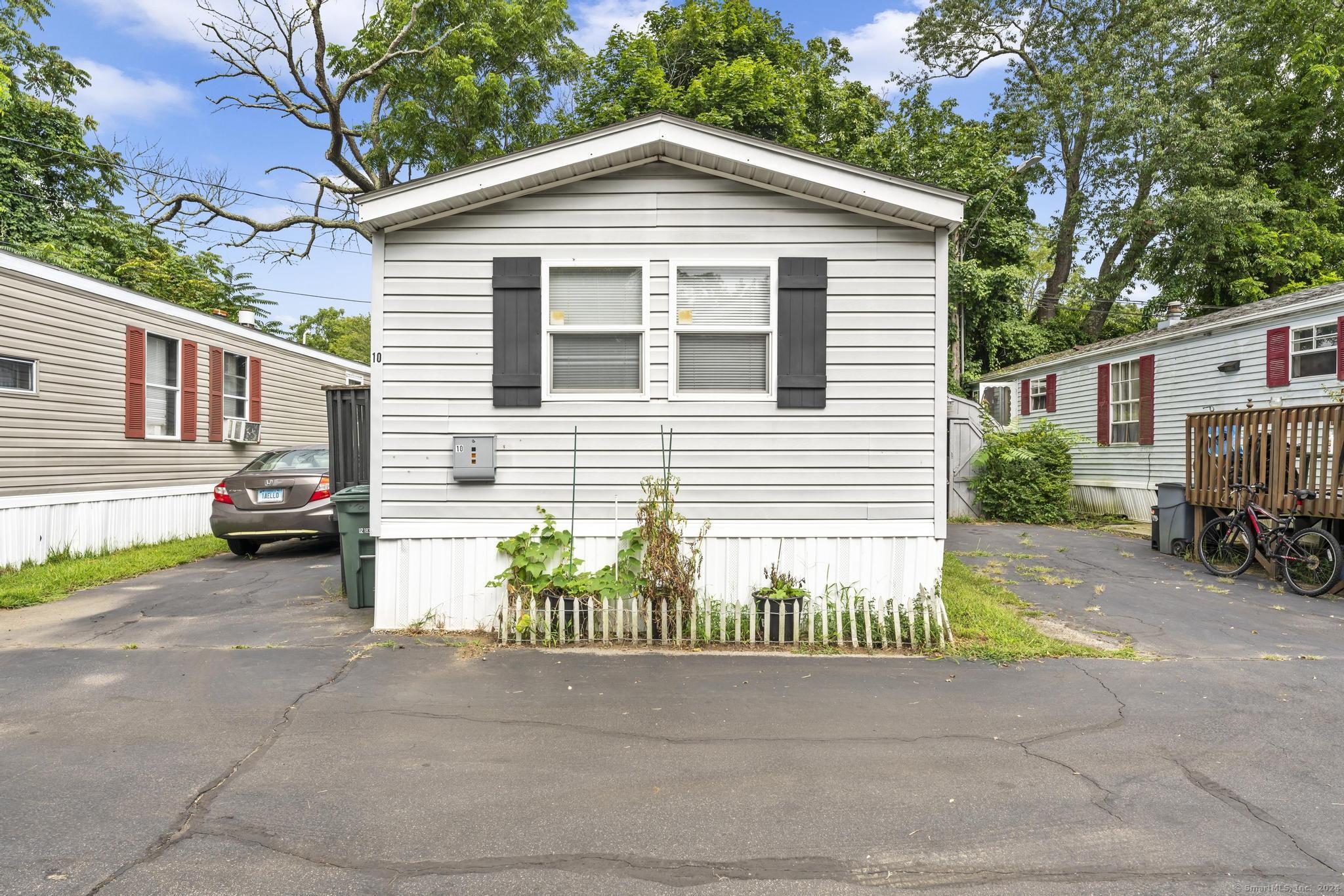 62 Fort Hill Road Groton, CT 06340 - Photo 1 of 1 a view of a house with a yard and parking area