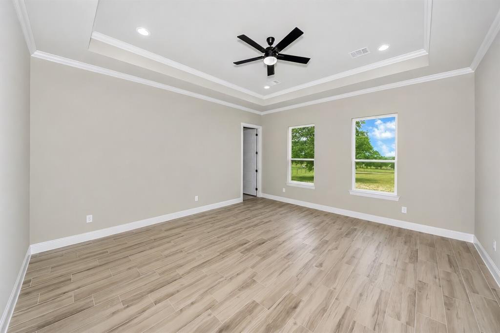 1057 Vh Ranch Poolville, TX 76487 - Photo 16 of 38 an empty room with wooden floor and windows