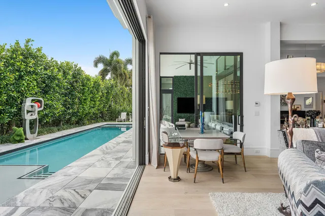 a bathroom with a granite countertop sink a toilet a mirror and shower