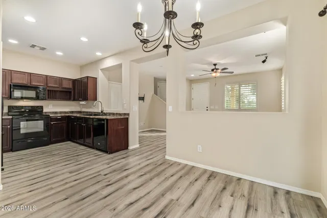 a kitchen with stainless steel appliances granite countertop a stove a sink and a microwave