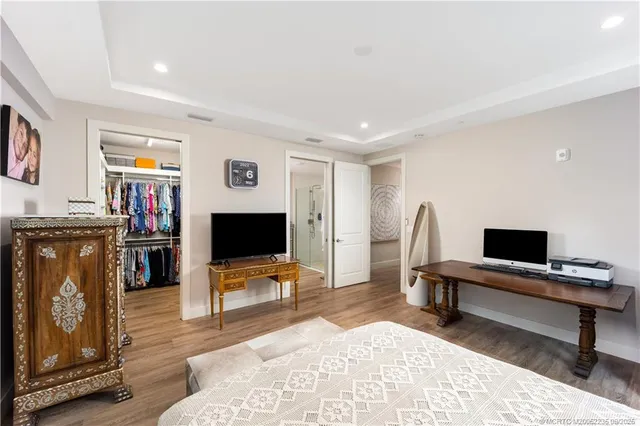 a living room with furniture a piano and a flat screen tv