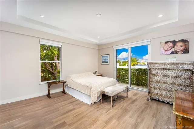a spacious bedroom with a bed and a large window