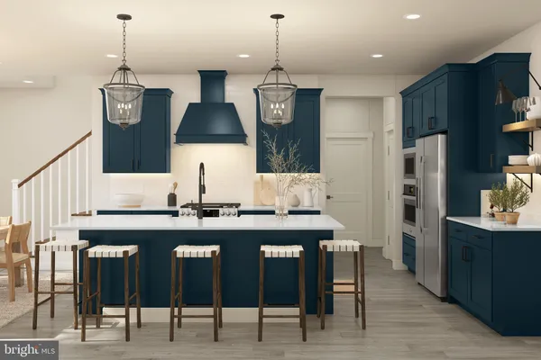 a kitchen with stainless steel appliances a kitchen island a stove and a cabinets