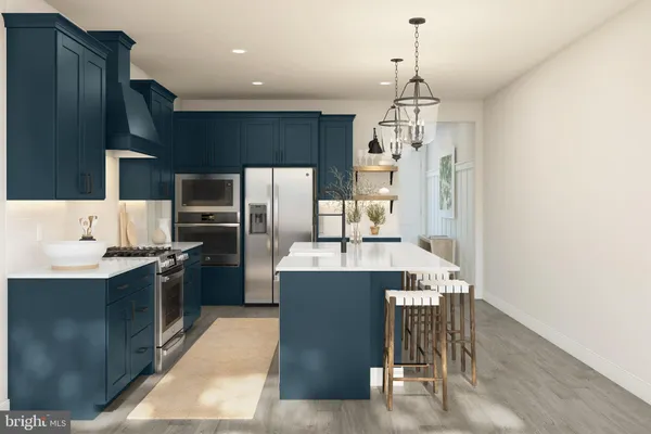 a kitchen with kitchen island a counter top space appliances and cabinets