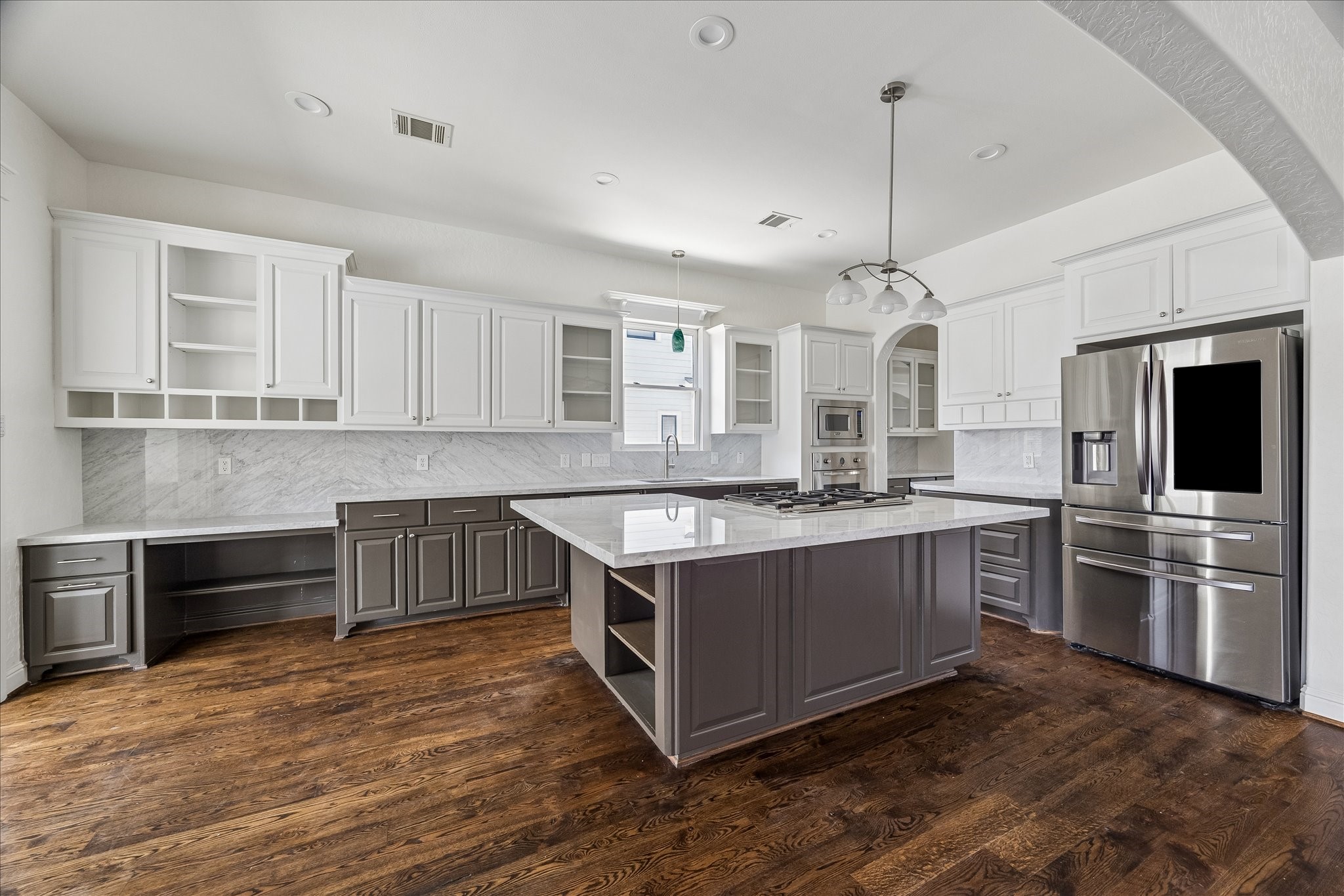 1408 West 23rd Street Houston, TX 77008 - Photo 15 of 40 Bright kitchen with fresh paint, brand new Carrara marble countertops and backsplash, large center island, and stainless appliances.