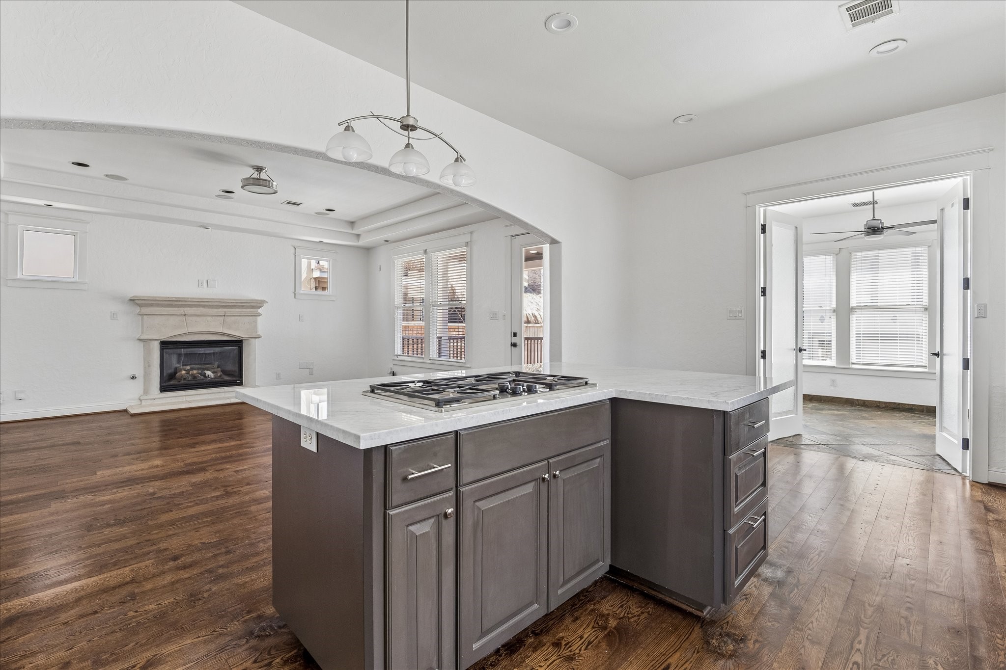 1408 West 23rd Street Houston, TX 77008 - Photo 16 of 40 An alternate view of the expansive kitchen featuring marble-topped island, extensive cabinetry, and open flow into the living area—ideal for everyday living and entertaining.